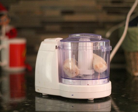 A fresh banana in a mini food processor