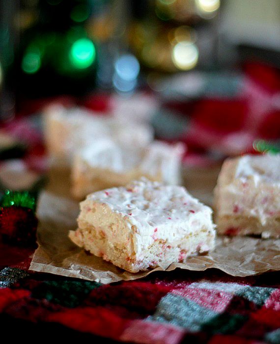 Squares of peppermint cookie bars on a red and green holiday-themed table