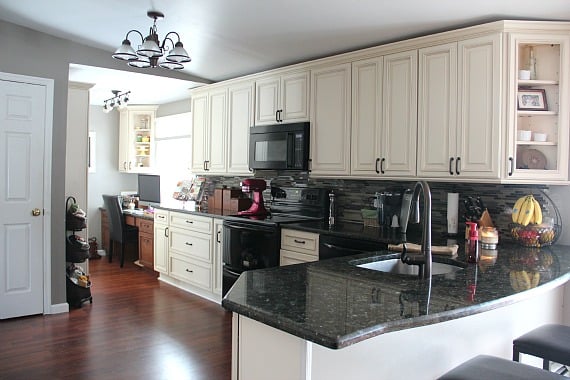 A remodeled kitchen with white cabinets
