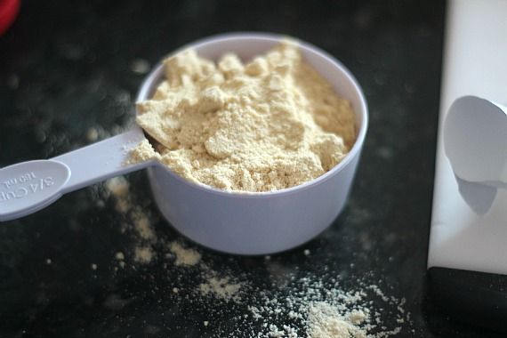 Malted milk powder in a measuring cup