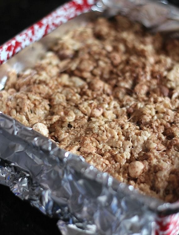 Malted milk ball rice krispie treats in a foil-lined pan