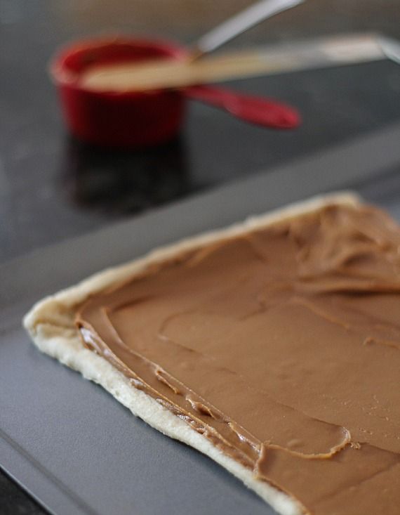 A rectangle of crescent roll dough topped with biscoff spread