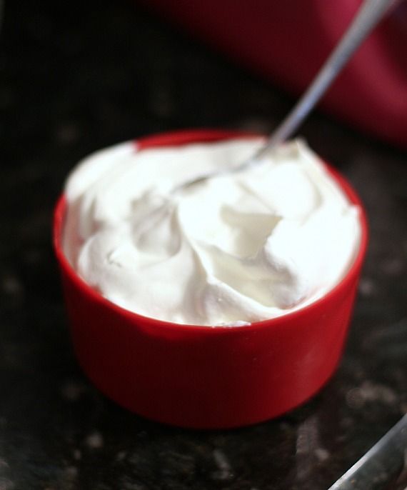 A measuring cup of whipped cream