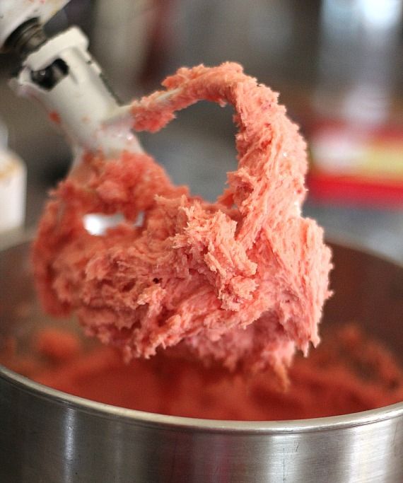 Strawberry cake mix cookie batter on a stand mixer paddle.