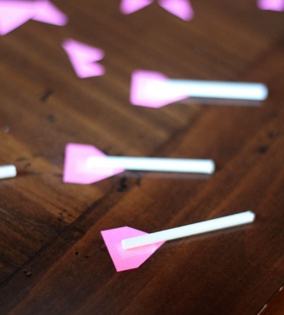 Pink arrow feathers on lollipop sticks