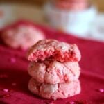 A stack of three pink strawberry cake mix cookies.