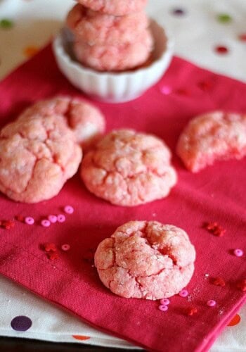 Strawberry cake mix cookies laid out on a pink napkin.