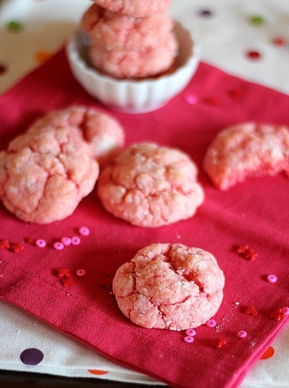 Strawberry cake mix cookies laid out on a pink napkin.