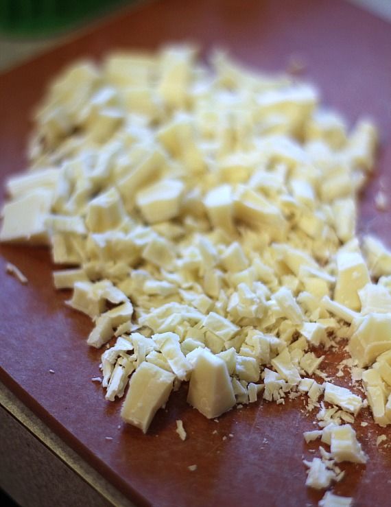 Finely chopped white chocolate on a cutting board