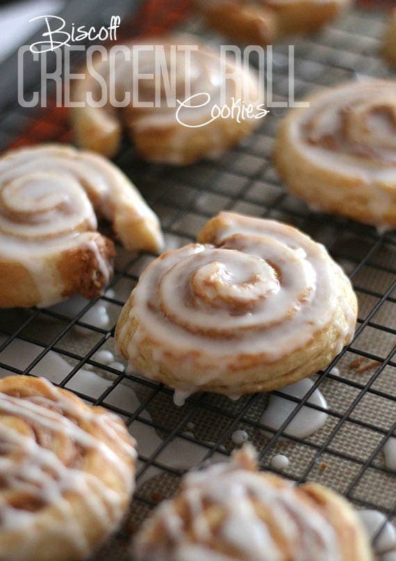 Overhead view of Biscoff Roll Cookies with glaze on a cooling rack