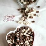 Overhead view of chocolate covered cheerios in a heart-shaped dish