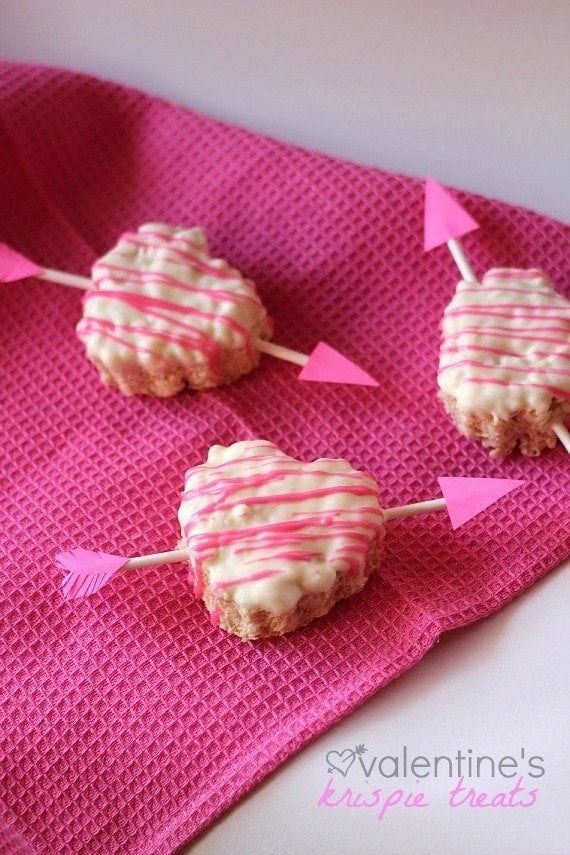 Valentine's Heart Krispie Treats with cupid arrows on a pink napkin