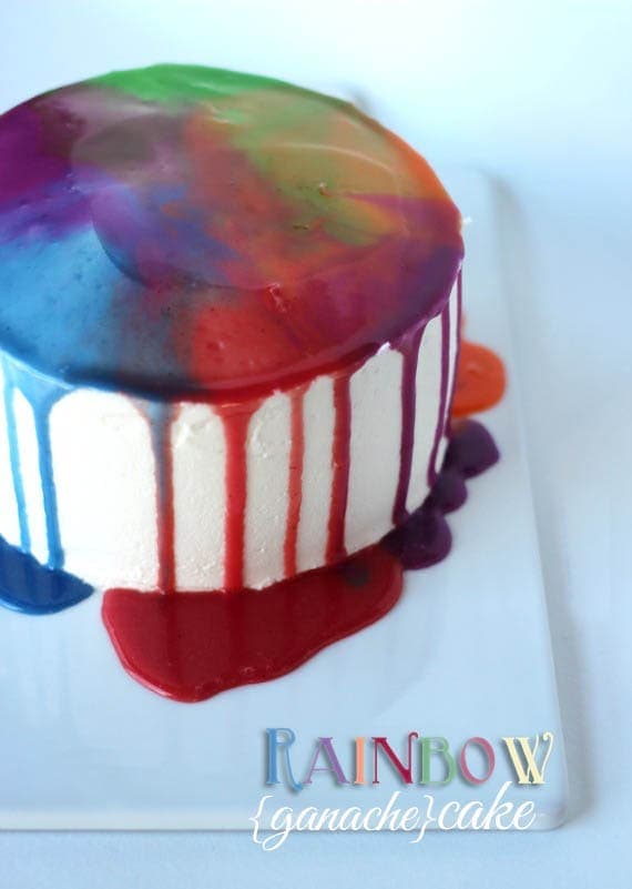 A rainbow ganache cake on a plate