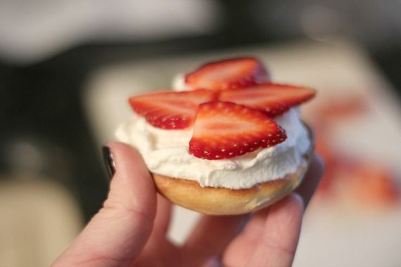 An open-faced shortcake whoopie pie topped with whipped cream and strawberry slices