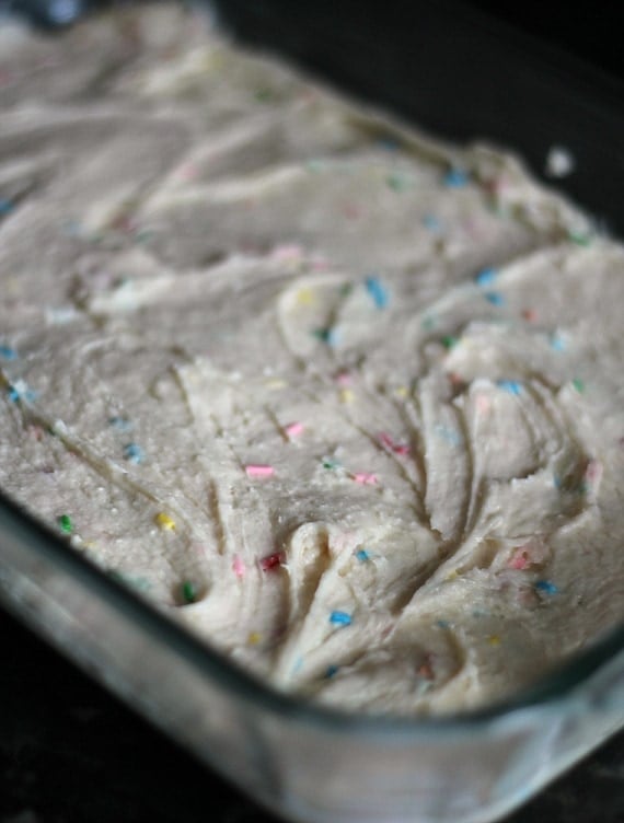 Funfetti cake batter spread in a baking dish