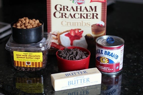 Baking ingredients including graham cracker crumbs, butter, sweetened condensed milk, chocolate chips, butterscotch chips and mini peanut butter cups