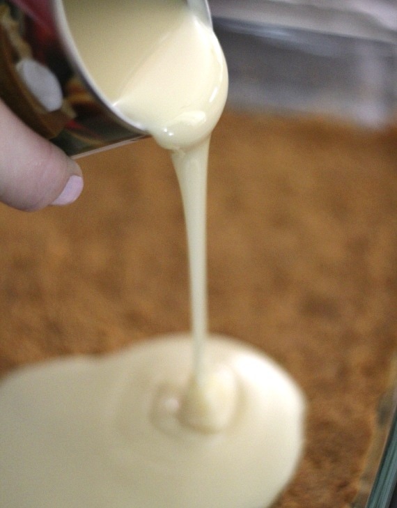 Sweetened condensed milk being poured from a can