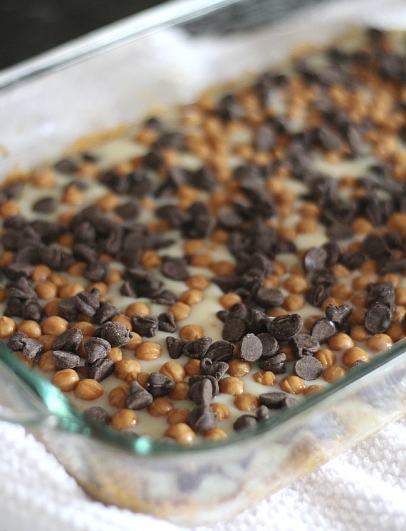 Blizzard bars in a baking dish with chocolate chips and toffee bits