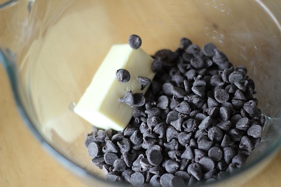 Chocolate chips and butter in a glass mixing bowl