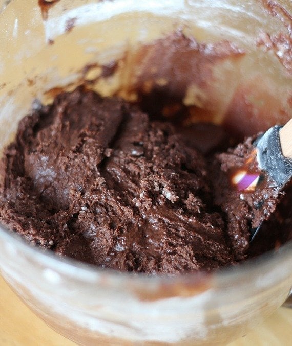 Thick chocolate batter in a mixing bowl with a spatula
