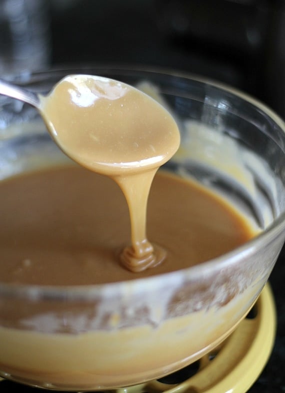 Melted butter and caramel in a bowl with a spoon