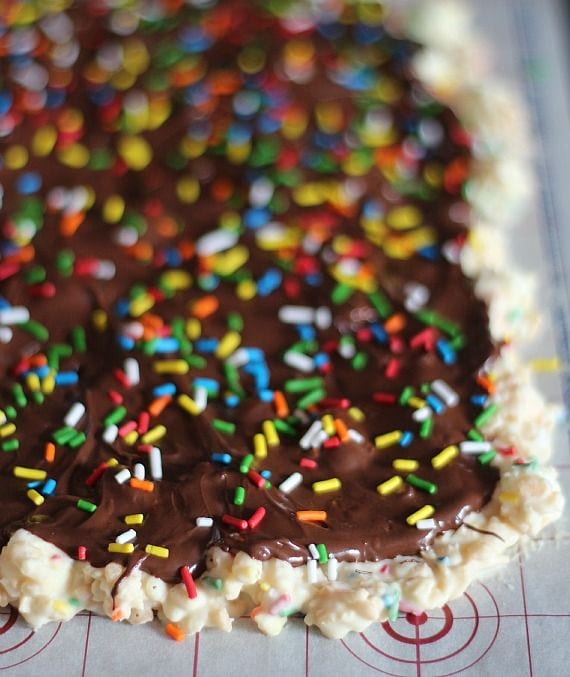 Chocolate-covered rice krispie treats with rainbow sprinkles