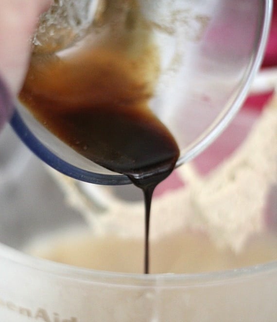 Close-up of stout syrup being poured into a mixing bowl