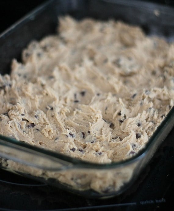 Chocolate chip cookie dough spread in a 9x13 baking dish