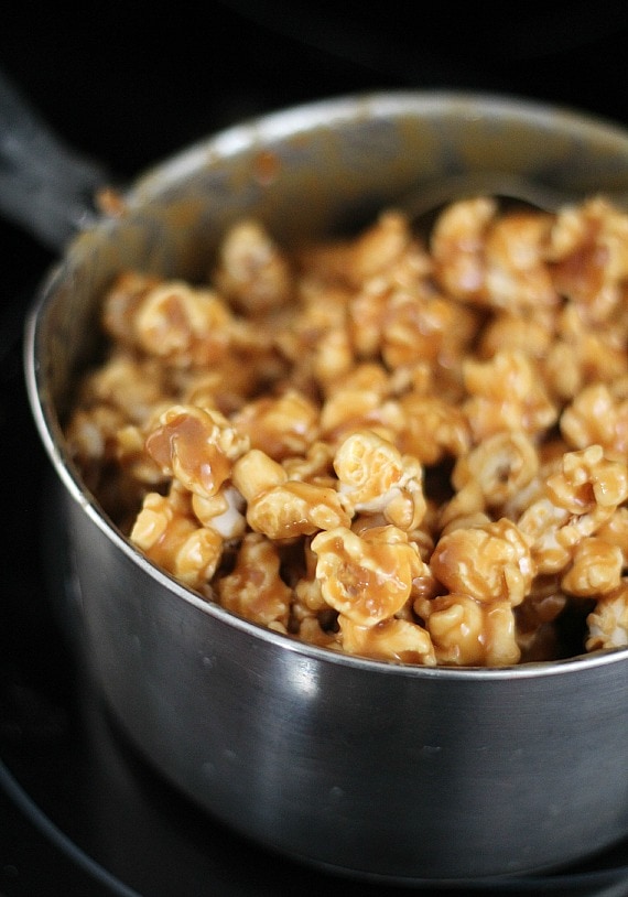 Popcorn coated with peanut butter sauce in a mixing bowl