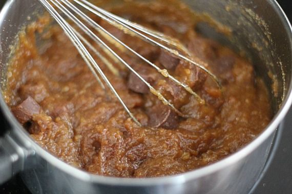 Chocolate batter with rolo candies in a bowl with a whisk