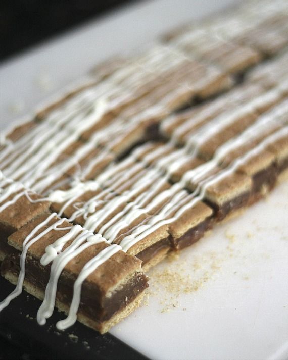 Graham Cracker Bars drizzled with icing on a cutting board