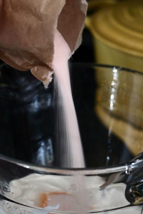 Sugar being added to a mixing bowl