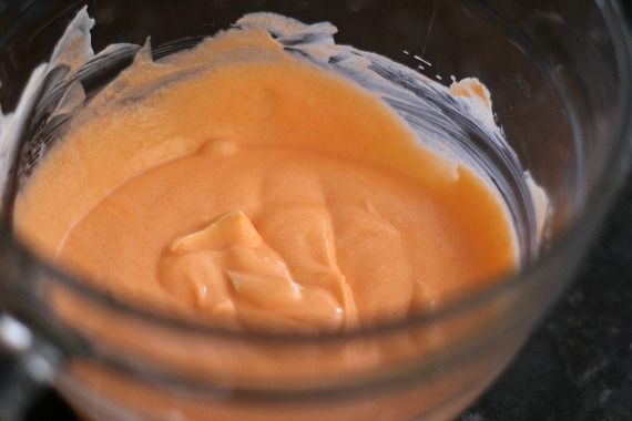 Orange Jello yogurt mixture in a mixing bowl