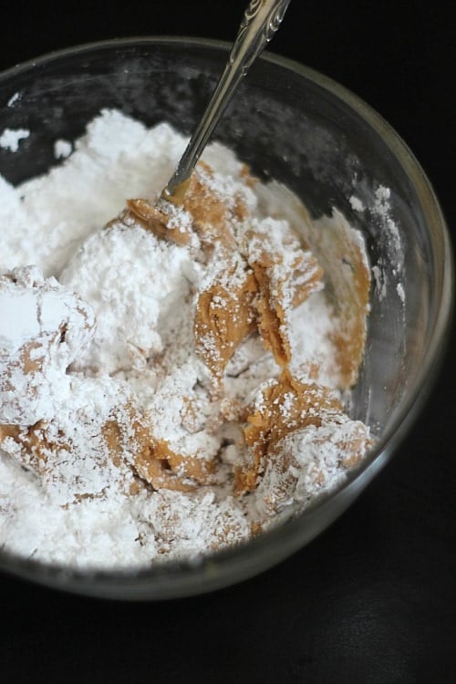 Peanut butter and powdered sugar in a mixing bowl