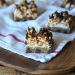 Squares of Chocolate Chip & Peanut Butter Popcorn Bars on a napkin