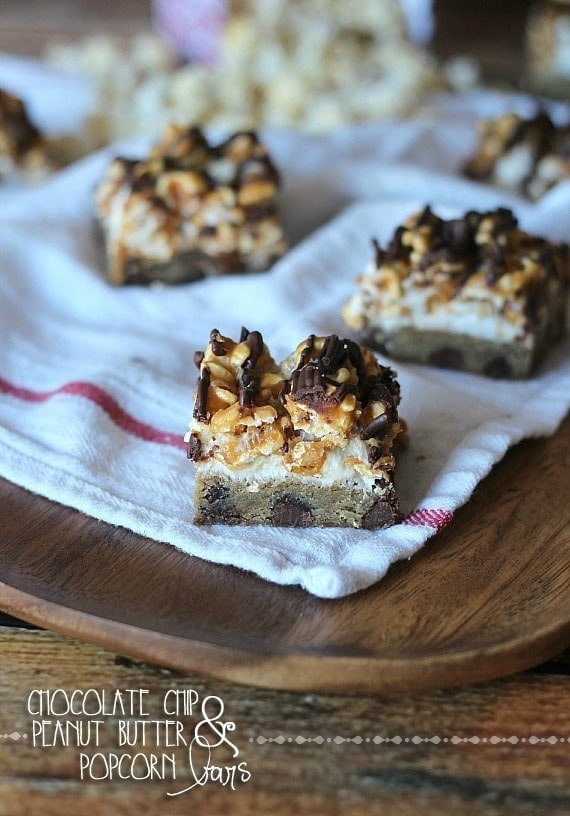 Squares of Chocolate Chip & Peanut Butter Popcorn Bars on a napkin