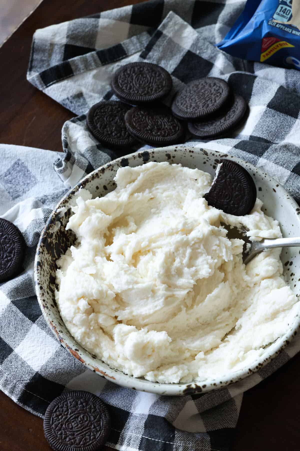 A bowl of Oreo Cookie Filling surrounded by Oreo cookies