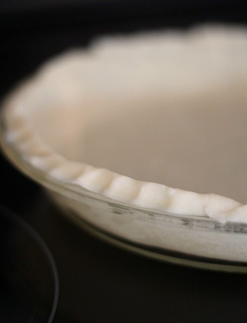 Unbaked pie crust with fluted edges in a pie plate