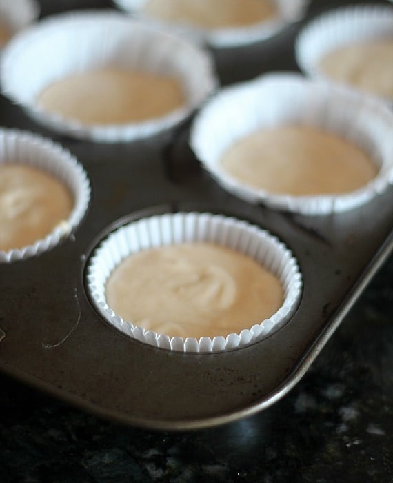 Vanilla muffin batter in paper-lined muffin tins