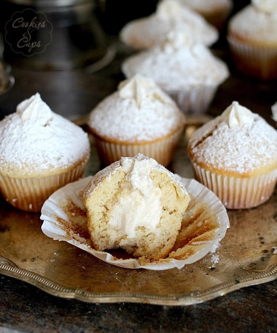 Vanilla Cream Filled Powdered Sugar Muffins on a platter