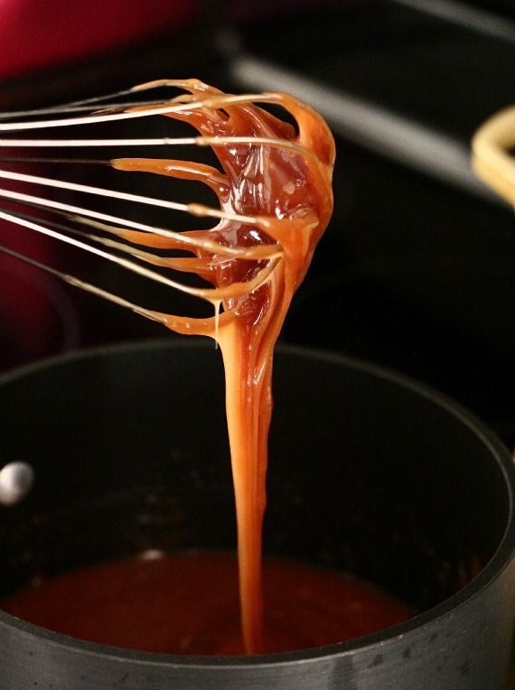 Caramel on a whisk over a saucepan