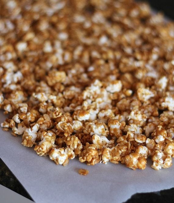 Peanut butter caramel corn on parchment paper after baking