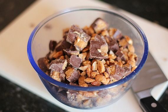 Bowl of peanut butter cups and chopped peanuts