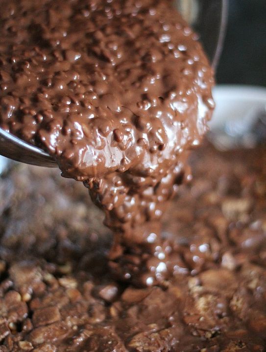 Pouring melted chocolate mixed with Rice Krispie cereal