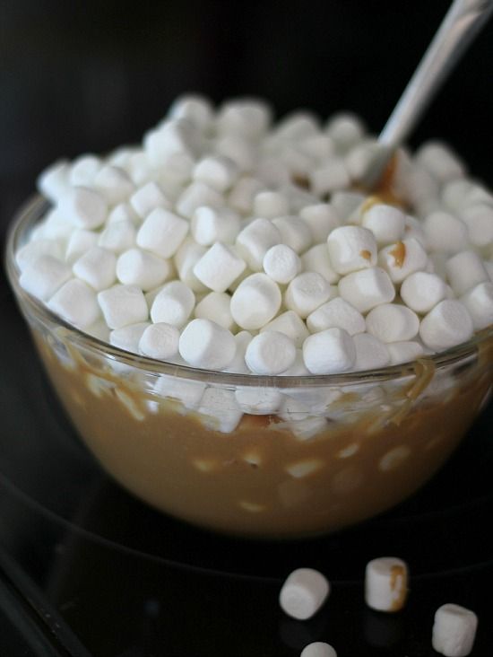 Mini marshmallows on top of melted butterscotch mixture in a bowl