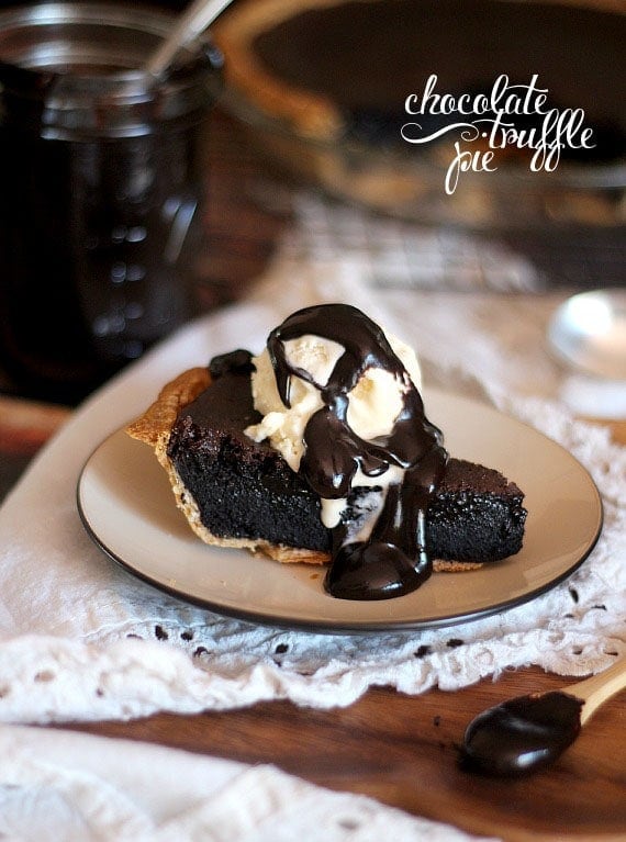 A serving of chocolate truffle pie with ice cream on a plate