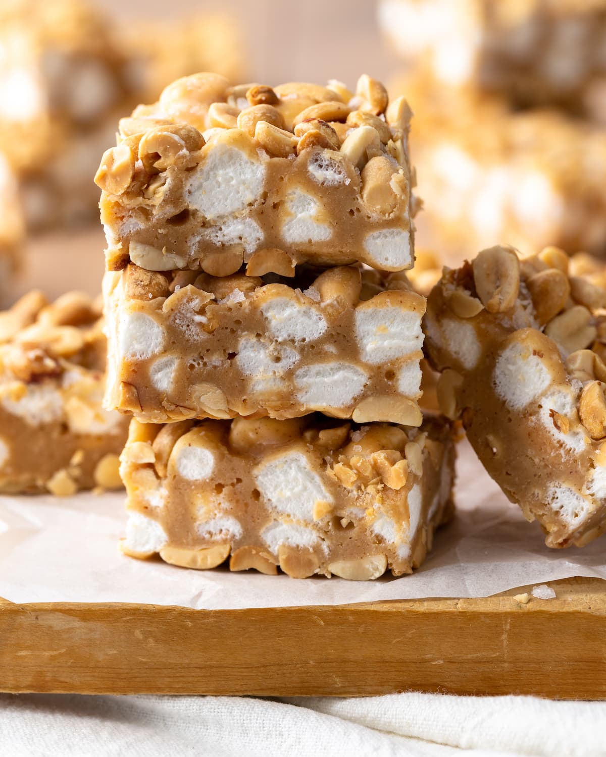 Three homemade PayDay bars stacked on top of one another, surrounded by the other bars.