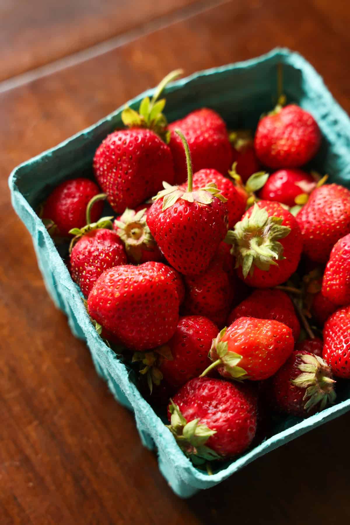 A small basket of fresh strawberries