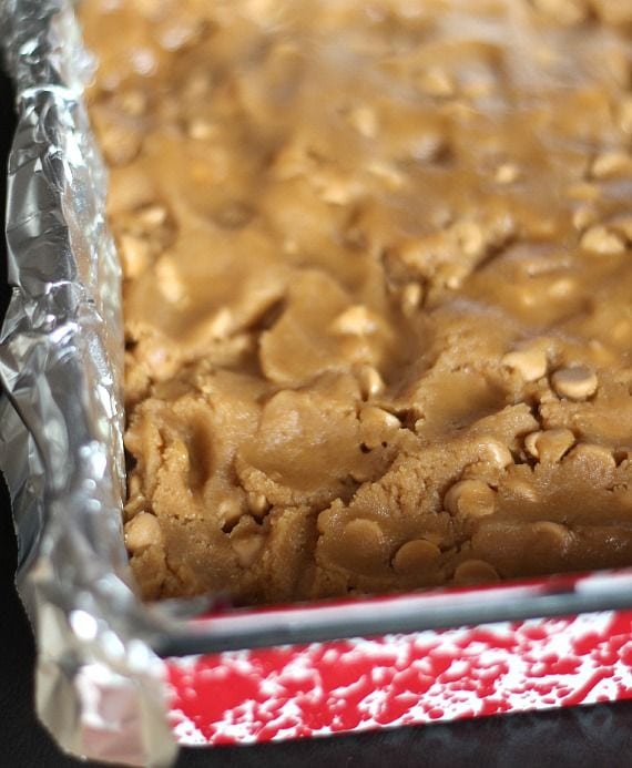 Peanut butter blondie dough pressed into a baking pan