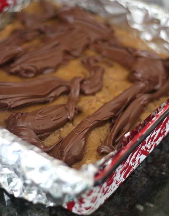 Nutella dropped on top of blondie batter in a baking pan